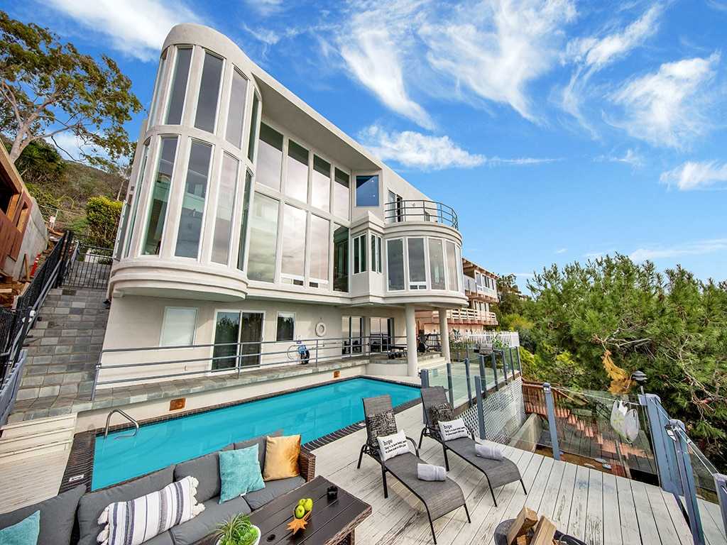 Oceanfront estate exterior with pool